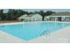 Community pool with clear blue water, metal ladders, and a lifeguard ring on a nearby fence at 2754 Legacy Ridge Ln, Catawba, NC 28609