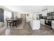 Open-concept kitchen with a dining area, featuring white cabinets, stainless steel appliances, and wood flooring at 2754 Legacy Ridge Ln, Catawba, NC 28609