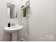 This powder room has a pedestal sink, modern faucet, and decorative towel rack at 2754 Legacy Ridge Ln, Catawba, NC 28609