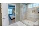 Bathroom featuring a tiled shower and a view into an adjacent bedroom at 3424 Saint Clair Nw Ct, Concord, NC 28027