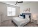 Bright bedroom with a ceiling fan, carpeted floors, and a queen-sized bed with grey headboard at 3424 Saint Clair Nw Ct, Concord, NC 28027