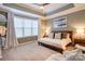 Comfortable bedroom with neutral tones, complemented by a tray ceiling and soft carpeting at 3424 Saint Clair Nw Ct, Concord, NC 28027