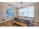 Sunlit dining room featuring a rustic wooden table with bench seating and modern chandelier at 3424 Saint Clair Nw Ct, Concord, NC 28027