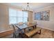 Bright dining area features a wooden table with bench seating under a modern light fixture at 3424 Saint Clair Nw Ct, Concord, NC 28027