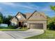 Attractive home with a well-manicured lawn, a two-car garage, and inviting front porch under a bright, sunny sky at 3424 Saint Clair Nw Ct, Concord, NC 28027