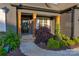 Inviting front porch of home is adorned with natural wood supports and lush landscaping at 3424 Saint Clair Nw Ct, Concord, NC 28027