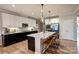 Modern kitchen with granite countertops, stainless steel appliances, and a breakfast bar with seating at 3424 Saint Clair Nw Ct, Concord, NC 28027