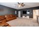 Recreation room featuring a TV, ceiling fan, dark grey walls, carpeted floors, and a sectional at 3424 Saint Clair Nw Ct, Concord, NC 28027