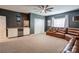 Recreation room with cabinets, built in refrigerator, carpeted floors, ceiling fan and a large sectional at 3424 Saint Clair Nw Ct, Concord, NC 28027