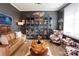 Inviting living room showcasing custom display cabinets, comfortable seating, and ample natural light at 3424 Saint Clair Nw Ct, Concord, NC 28027
