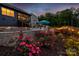 Inviting backyard pool with spa featuring travertine tile and manicured landscaping with rose bushes at 3424 Saint Clair Nw Ct, Concord, NC 28027