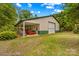 Spacious barn featuring a roll-up door and a covered lean-to area for equipment storage at 3755 River Rd, Richfield, NC 28137