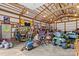 Large barn interior with exposed beams, filled with equipment and tools at 3755 River Rd, Richfield, NC 28137