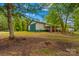 Side view of barn with covered storage and green and cream color scheme at 3755 River Rd, Richfield, NC 28137