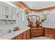 Traditional bathroom featuring wood vanities, hanging plants, and vintage mirrors at 3755 River Rd, Richfield, NC 28137
