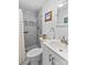 Modern bathroom featuring a tiled shower, white vanity, and ample lighting at 3755 River Rd, Richfield, NC 28137