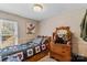 Charming bedroom with a twin bed, dresser, and wallpaper with natural light from the window at 3755 River Rd, Richfield, NC 28137