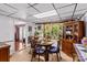 Sunlit dining room with unique glass-top table and cozy seating by the window with hanging plants at 3755 River Rd, Richfield, NC 28137