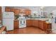 Kitchen area with light wood cabinets, appliances, and hard wood flooring at 3755 River Rd, Richfield, NC 28137