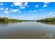 Panoramic lake view showcasing serene waters and lush surrounding trees at 3755 River Rd, Richfield, NC 28137