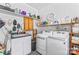 Functional laundry room with front load washer and dryer, ample shelving, and a utility sink at 3755 River Rd, Richfield, NC 28137