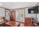 Well-lit living space with wood paneling, french doors to the exterior, and an entertainment center at 3755 River Rd, Richfield, NC 28137