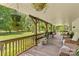Outdoor covered porch featuring plenty of room for outdoor furniture and views of the back yard at 3755 River Rd, Richfield, NC 28137