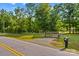 Gated property entrance on a quiet road with manicured landscaping at 3755 River Rd, Richfield, NC 28137