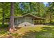 Exterior view of storage shed with lean-to and mature trees at 3755 River Rd, Richfield, NC 28137