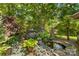 Outdoor koi pond with rock waterfall and custom landscaping at 3755 River Rd, Richfield, NC 28137