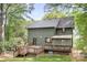The back of the house featuring a deck, screened in porch, and well-maintained yard at 4316 Old Saybrook Ct, Charlotte, NC 28211