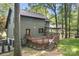 Back exterior view of the house with a large deck, screened-in porch, and well-maintained yard at 4316 Old Saybrook Ct, Charlotte, NC 28211