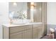 A bathroom with gray cabinets, double vanity, gold faucets, and modern decor with a white countertop at 4316 Old Saybrook Ct, Charlotte, NC 28211