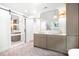Bright bathroom featuring a double vanity, gold fixtures, and a sliding barn door for the closet at 4316 Old Saybrook Ct, Charlotte, NC 28211