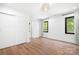 Bright bedroom featuring hardwood floors, a large window, neutral walls, and modern ceiling fan at 4316 Old Saybrook Ct, Charlotte, NC 28211