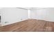 Spacious bedroom featuring hardwood floors, white walls, a modern ceiling fan, and a closet at 4316 Old Saybrook Ct, Charlotte, NC 28211