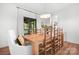 Dining room with a large wooden table and chairs, light fixtures, and access to the patio at 4316 Old Saybrook Ct, Charlotte, NC 28211