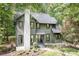 Two-story home with green siding, black trim, a white brick chimney and lovely front yard at 4316 Old Saybrook Ct, Charlotte, NC 28211