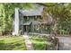 Charming home with an olive green exterior, stone chimney, and landscaped front yard at 4316 Old Saybrook Ct, Charlotte, NC 28211