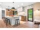 Well-lit kitchen featuring a large island with seating, hardwood floors, and a door to the outdoor at 4316 Old Saybrook Ct, Charlotte, NC 28211