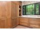 Custom kitchen featuring beautiful wood cabinetry with large windows and ample countertop space at 4316 Old Saybrook Ct, Charlotte, NC 28211