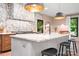 Bright kitchen features a large island with marble countertops, designer lighting, and stylish backsplash at 4316 Old Saybrook Ct, Charlotte, NC 28211
