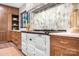 Well-appointed kitchen featuring custom cabinetry, a white stove and stainless steel hood at 4316 Old Saybrook Ct, Charlotte, NC 28211