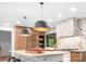 Stunning kitchen with custom cabinetry, a large island, pendant lights and a diamond patterned backsplash at 4316 Old Saybrook Ct, Charlotte, NC 28211