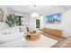 Bright and airy living room featuring white furniture, hardwood floors and large windows at 4316 Old Saybrook Ct, Charlotte, NC 28211