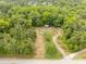 Charming aerial view of a home surrounded by a verdant green forest at 439 Kershaw Country Club Rd, Kershaw, SC 29067