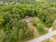 Aerial view of a cozy home nestled amongst dense trees and lush surroundings at 439 Kershaw Country Club Rd, Kershaw, SC 29067