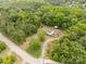 Aerial view of home featuring mature landscaping, a circular drive, and wooded surroundings at 439 Kershaw Country Club Rd, Kershaw, SC 29067