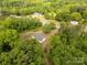 A high angle view of a home surrounded by dense lush trees and greenery at 439 Kershaw Country Club Rd, Kershaw, SC 29067