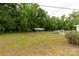 Wide backyard featuring lush landscaping with an outbuilding and carport at 439 Kershaw Country Club Rd, Kershaw, SC 29067